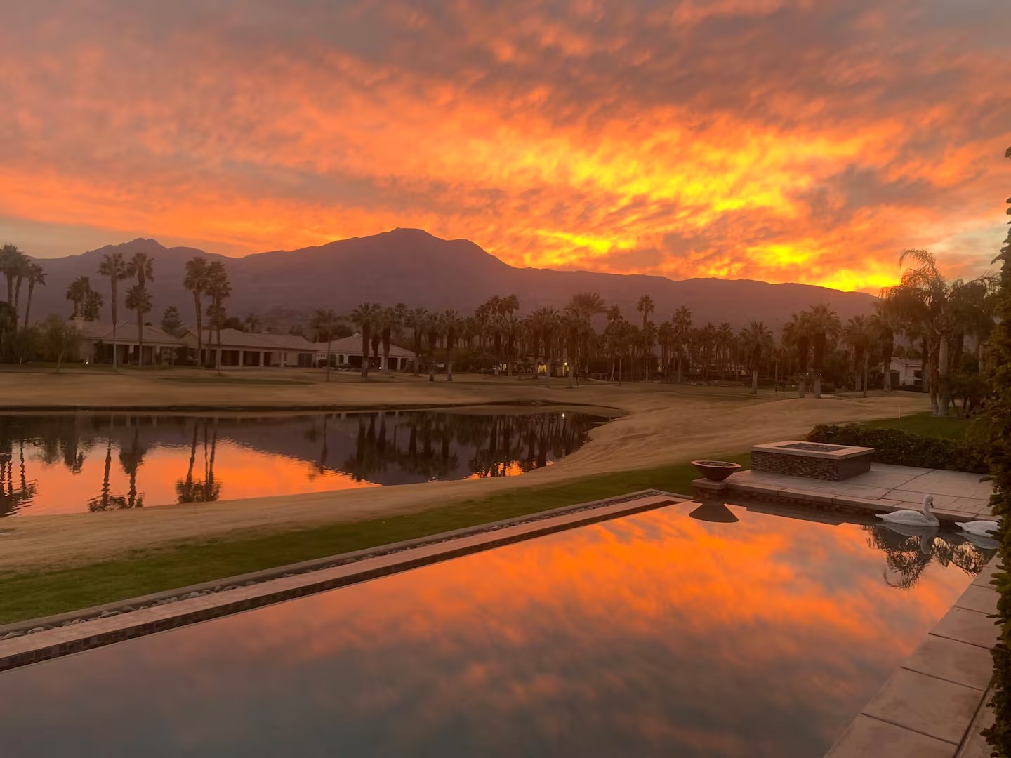 The Mason Oasis saltwater infinity pool with fire bowls and panoramic Santa Rosa Mountain views at PGA West, La Quinta California