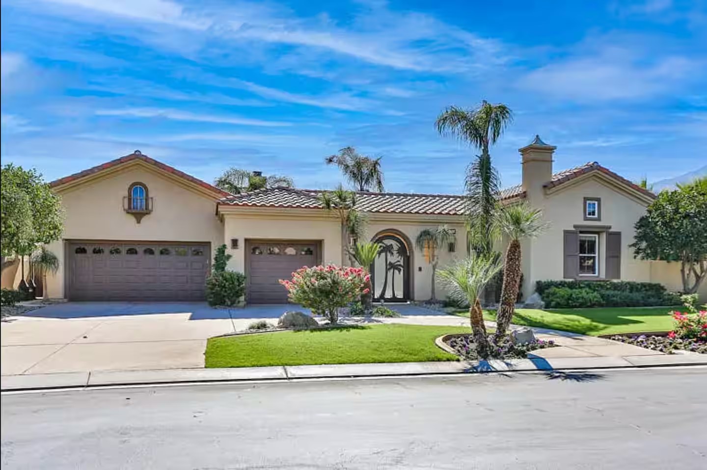Outdoor patio with BBQ kitchen island, fireplace, misting system, and desert views at The Mason Oasis La Quinta