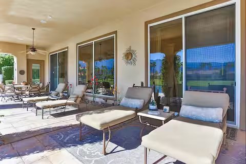 Patio lounge chairs with pool view at The Mason Oasis La Quinta