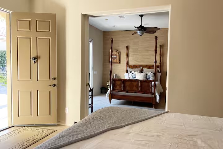 Private casita king bedroom with en suite bathroom, 50-inch TV, and kitchenette at The Mason Oasis luxury rental La Quinta California